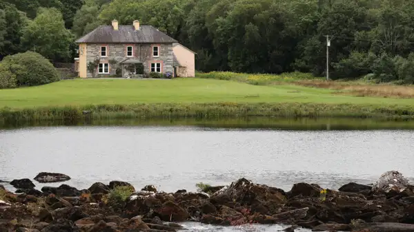 House at a river in Kerry mountains