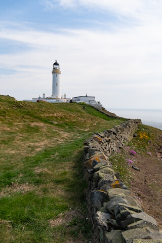 There are steep cliffs behind the little wall